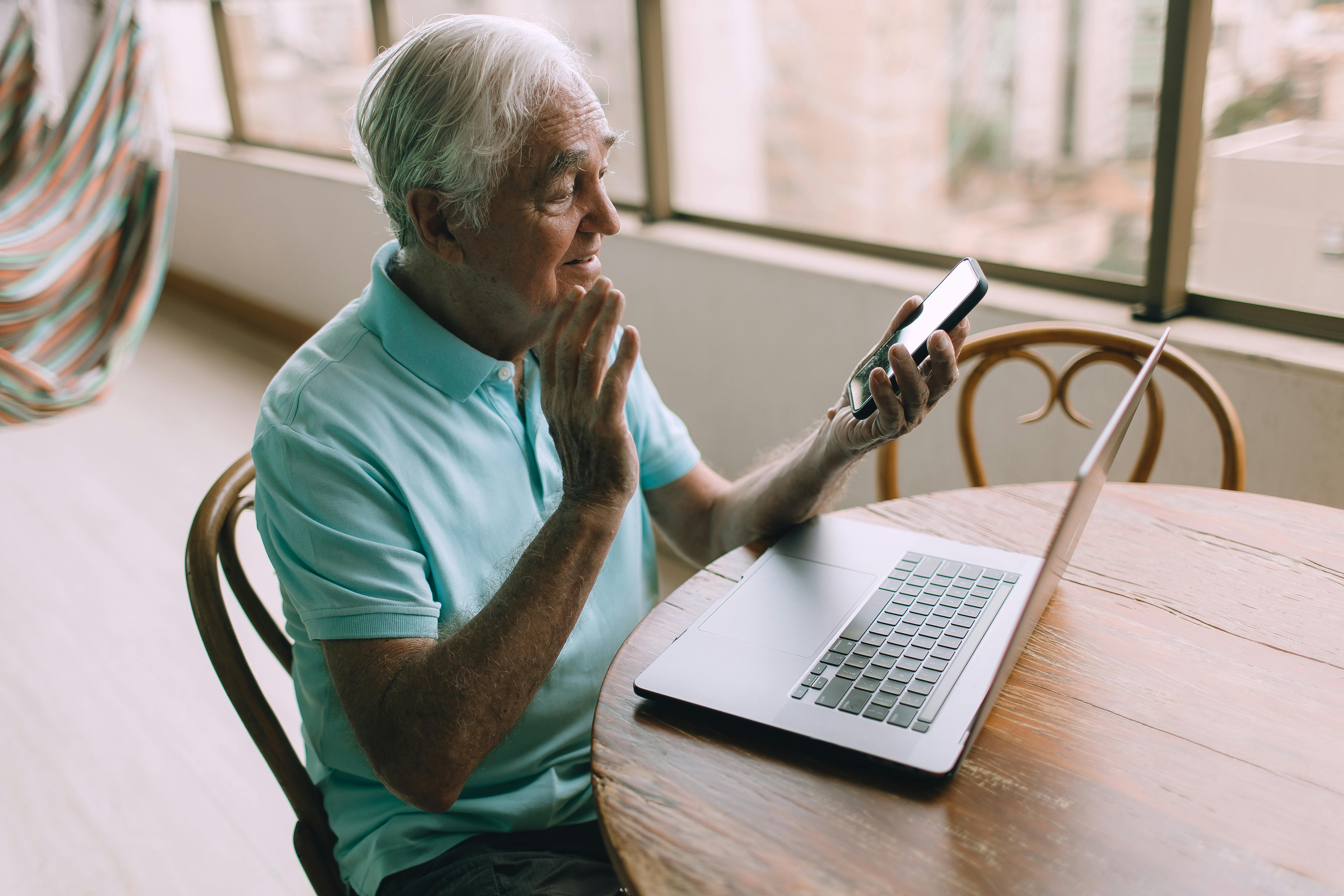Older man on video call with someone claiming to be tech support